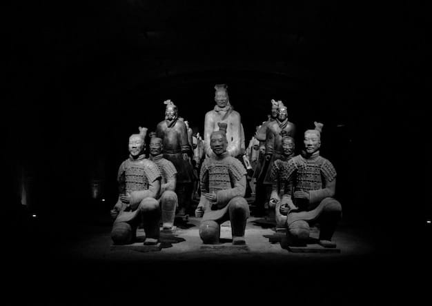 A grayscale band photo of Lamb of God, standing together in a dimly lit studio. The image conveys a sense of camaraderie and the band's collective intensity.