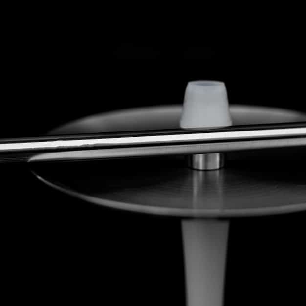 A close-up shot of a vinyl record spinning on a turntable, with the album cover depicting a desolate landscape. The overall tone is dark and moody, reflecting the aesthetic of doom metal.