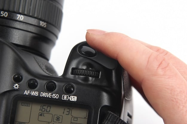 A close-up shot of a photographer's hands adjusting the settings on a DSLR camera. The focus is on the aperture, shutter speed, and ISO dials. The background is blurred, showing a concert stage with colorful lights.