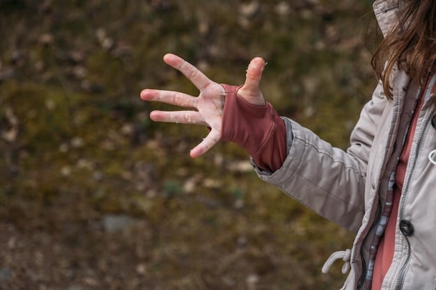 A close-up shot of a person in a mosh pit extending their hand to help someone up off the ground. The person helping is focused and determined, while the person being helped is reaching out gratefully. Other moshers are blurred in the background.