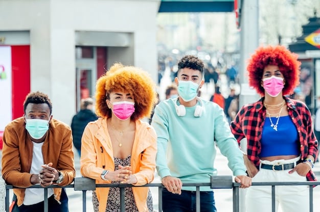A diverse group of people wearing face masks and maintaining social distance in a public space, representing the ongoing global pandemic and the importance of public health measures in mitigating the spread of infectious diseases.