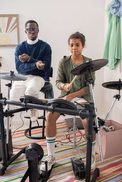 A diverse group of band members in a rehearsal room, actively listening to each other and engaged in a constructive discussion.