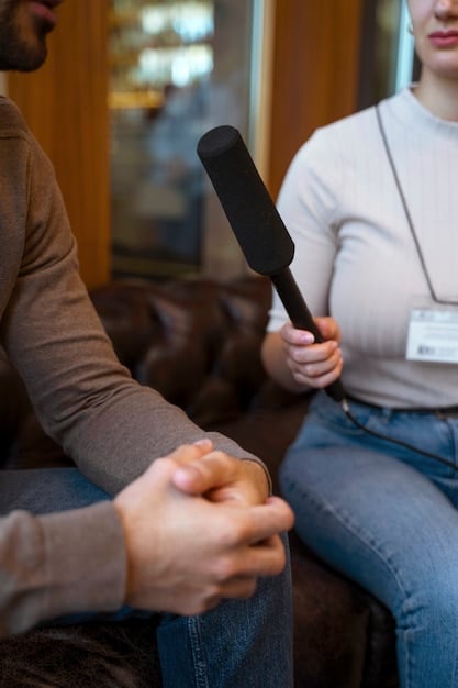 A band member calmly and confidently responding to a challenging question during an interview. The atmosphere is professional and respectful.