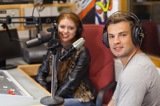 A band being interviewed on a local radio station, with the host smiling and engaging in a lively conversation with the band members. The studio is cozy and professional, equipped with microphones, mixing boards, and soundproofing panels, creating a warm and inviting atmosphere.