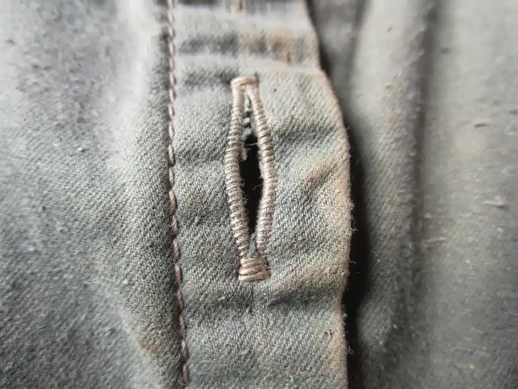Expertly repaired vintage buttonhole with fine stitching