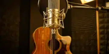 High-end condenser microphone capturing acoustic guitar in a professional studio