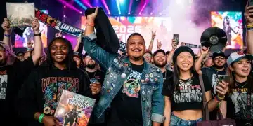 US music fans displaying modern band merchandise at a concert