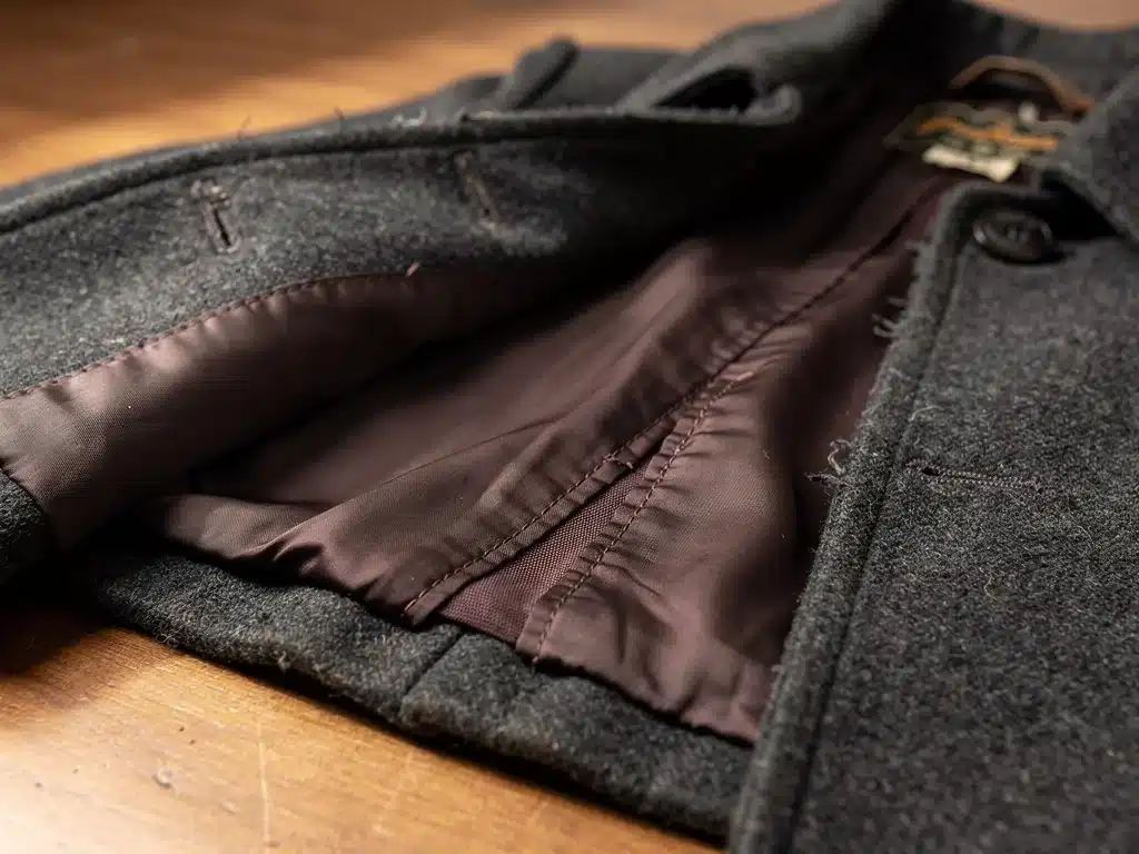 Detailed stitching and lining of a vintage wool coat